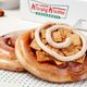 Krispy Kreme cinnamon rolls in front of Krispy Kreme box